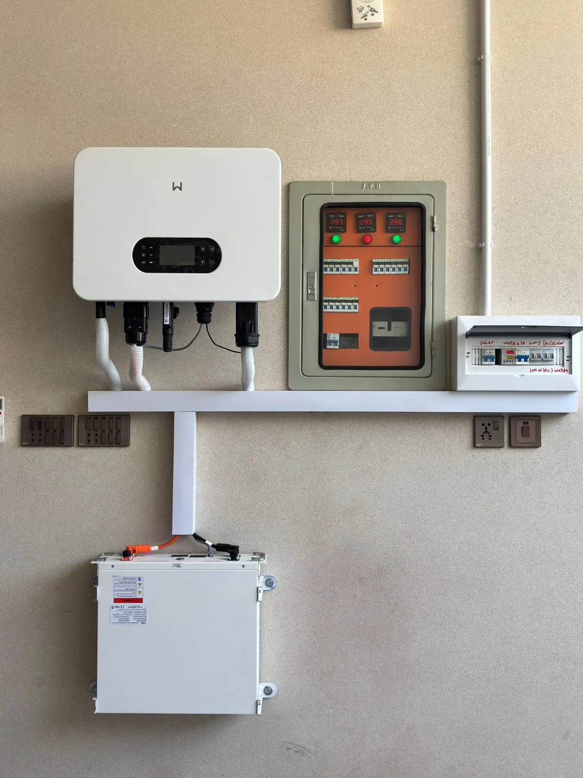 Hybrid inverter on a shelf above an enclosed protection box