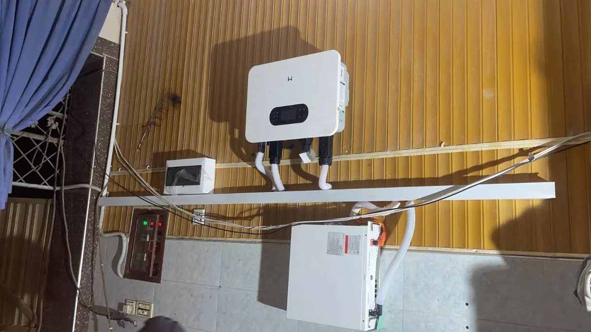 Inverter and conduit run along a wooden ceiling above a long cable tray