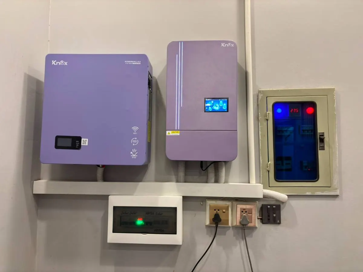 Two purple cased inverters with a protection board on a shelved wall
