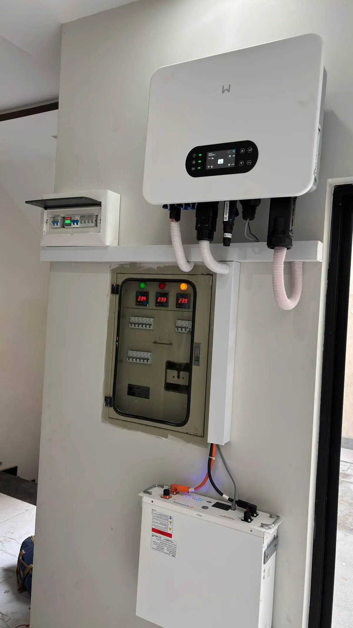 Hybrid inverter above an open protection board and a lithium battery
