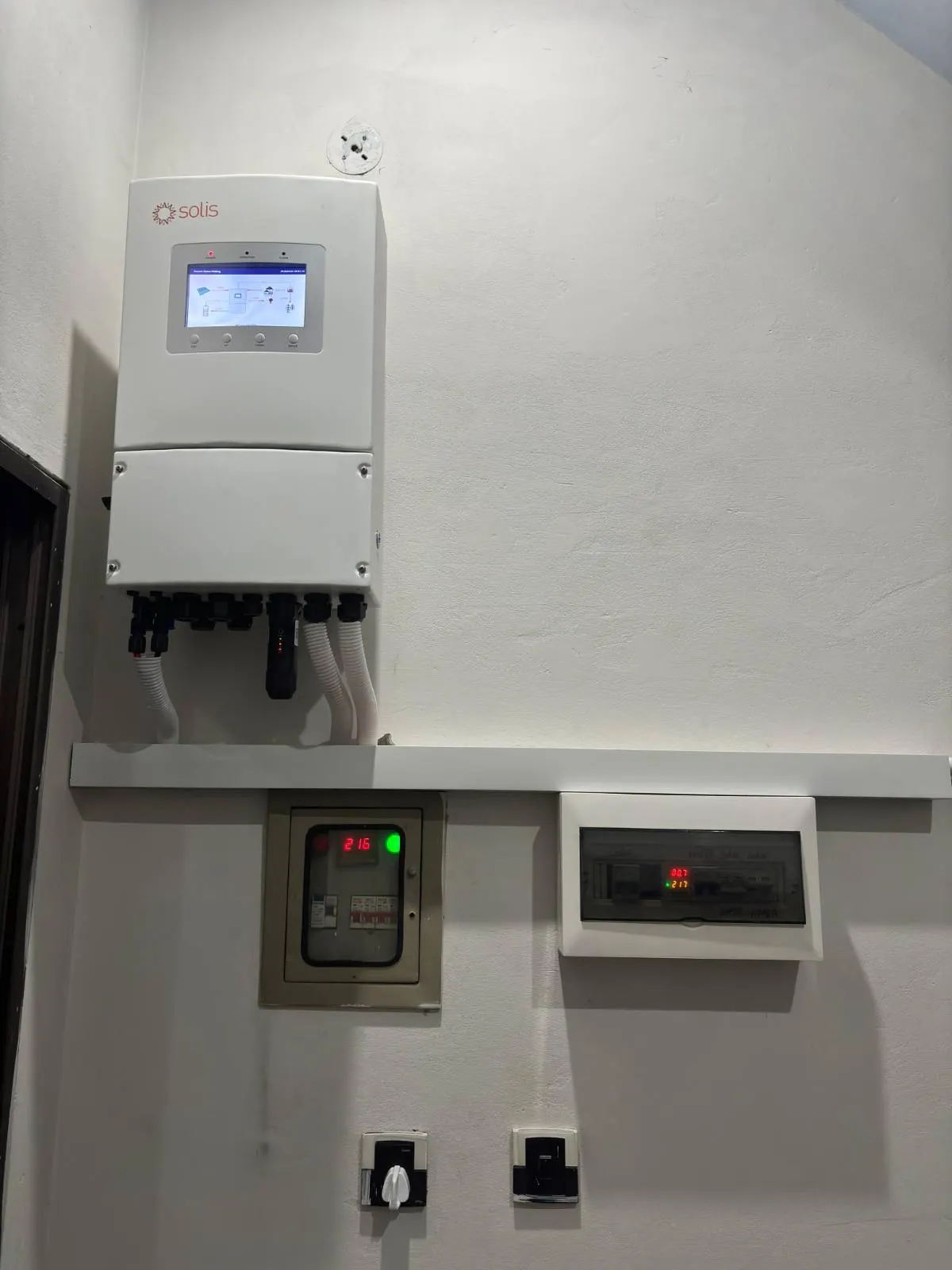 Hybrid inverter with conduit dropping to a meter and switch below