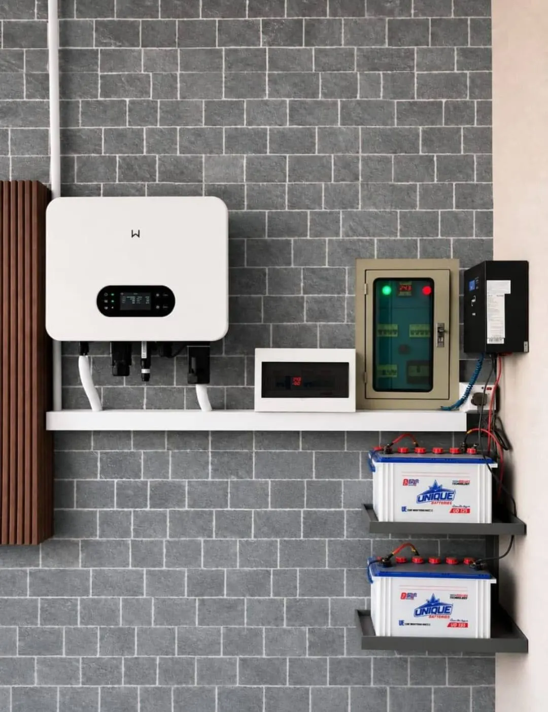 Hybrid inverter with two small lithium batteries on a tiled wall