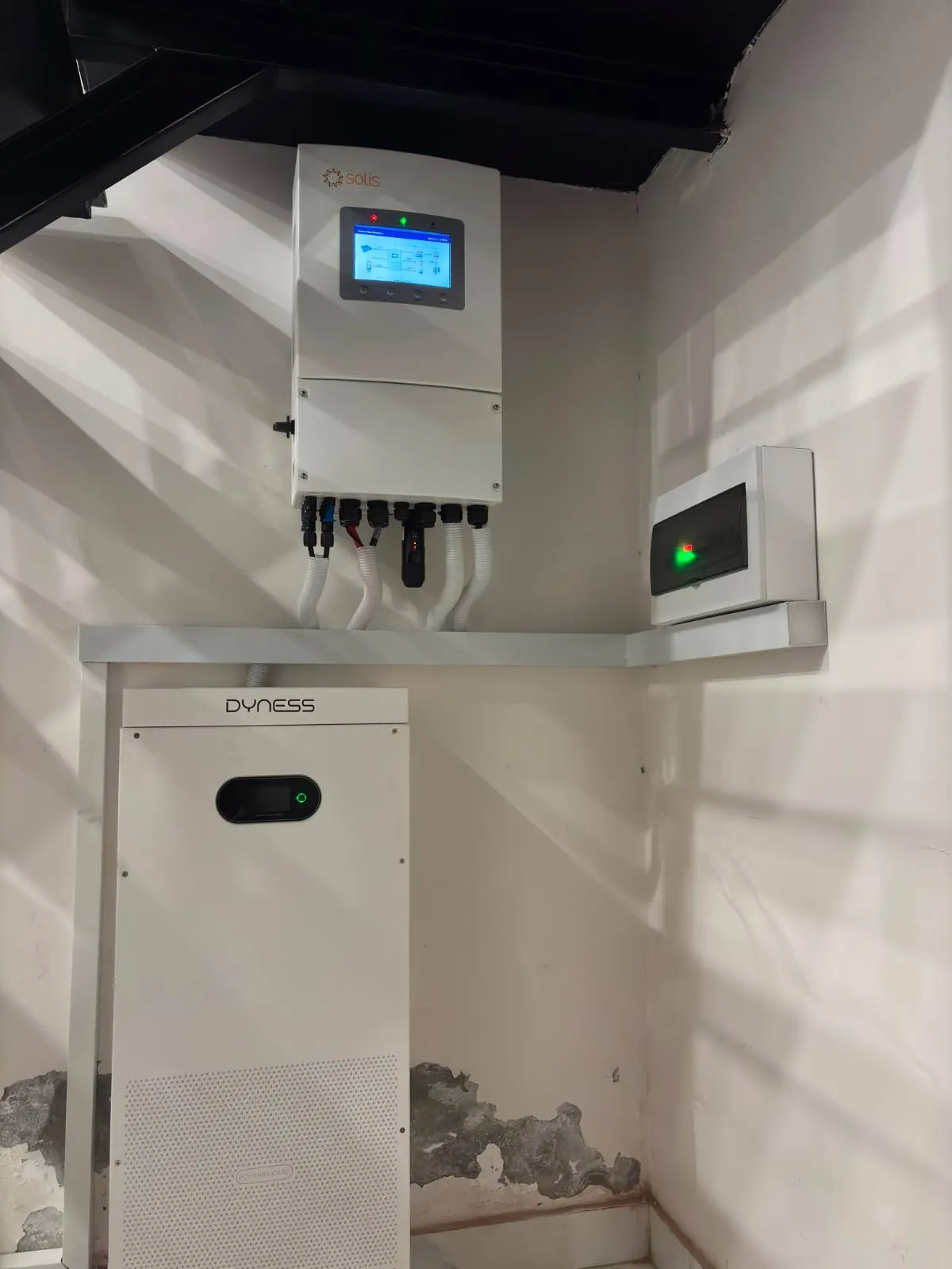Hybrid inverter above a tall floor standing lithium battery