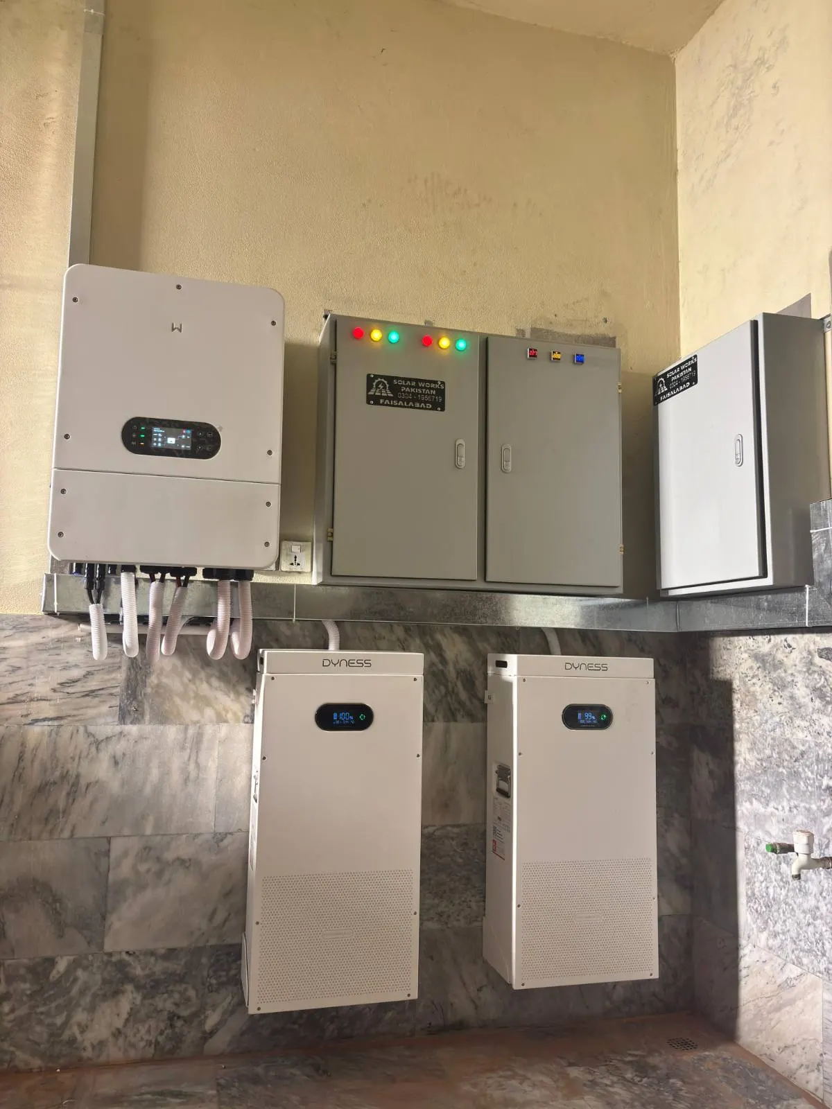 Hybrid inverter, two Dyness batteries and Solar Works Pakistan branded distribution boards in Faisalabad